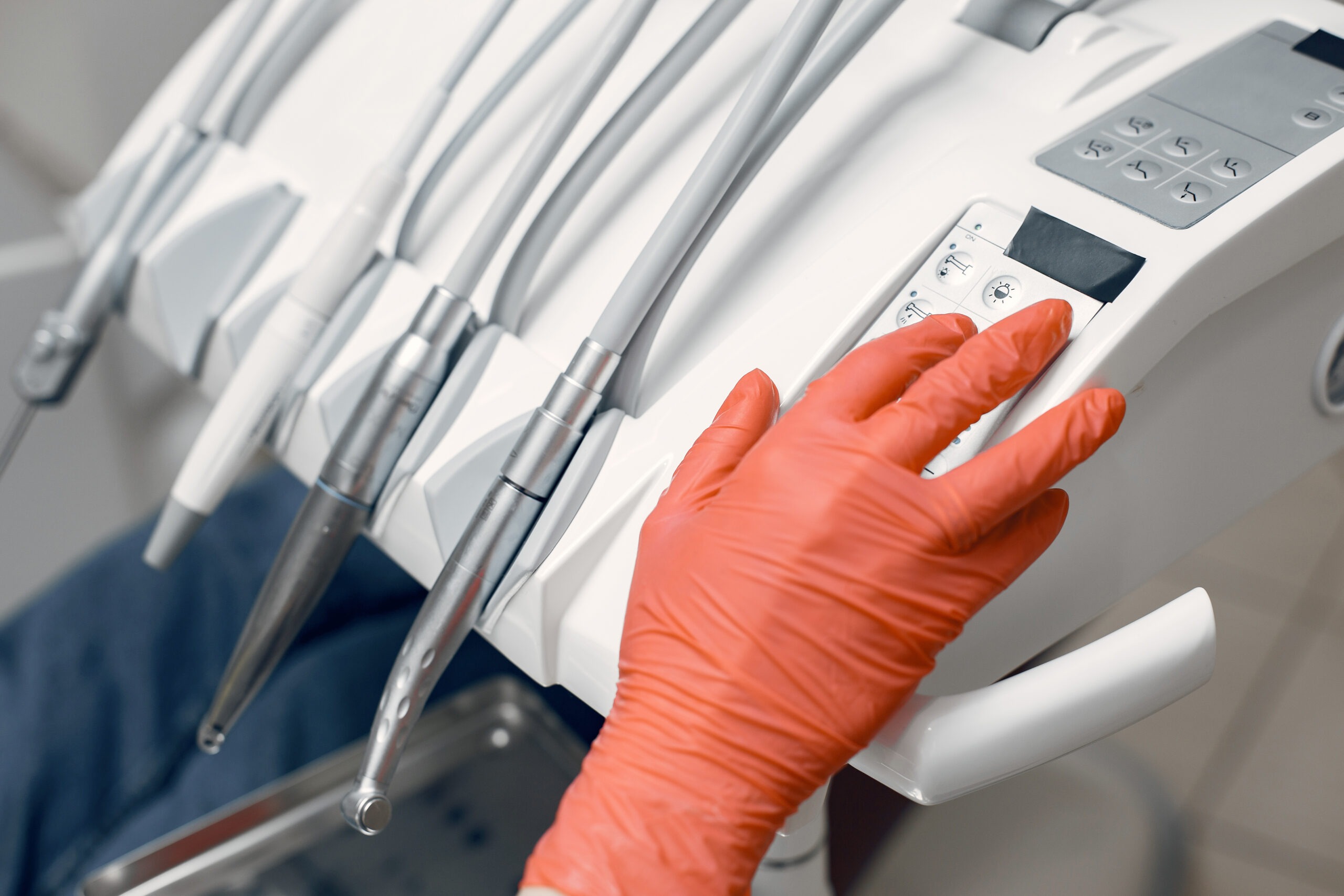 Dentist takes the instruments. Doctor in protective gloves.